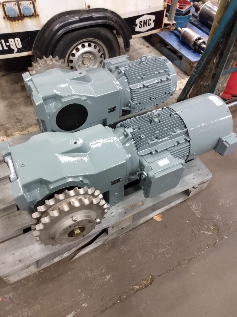 Industrial geared motor units on a pallet awaiting repair